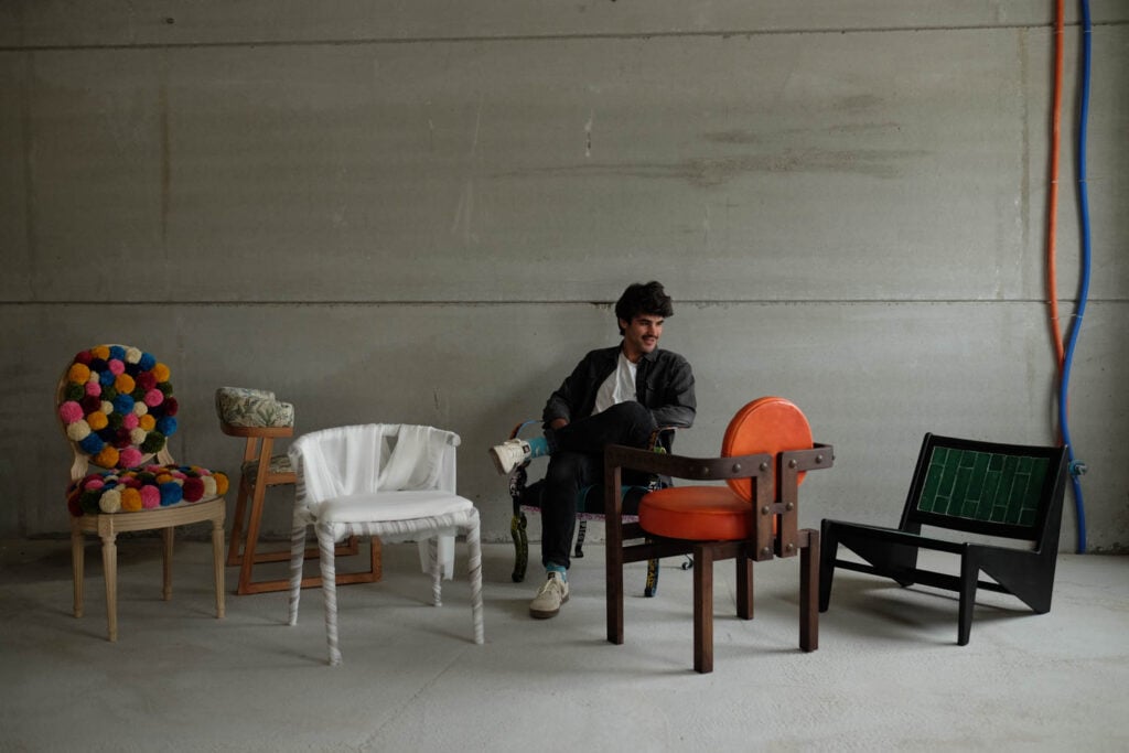 a person sitting in colored chairs