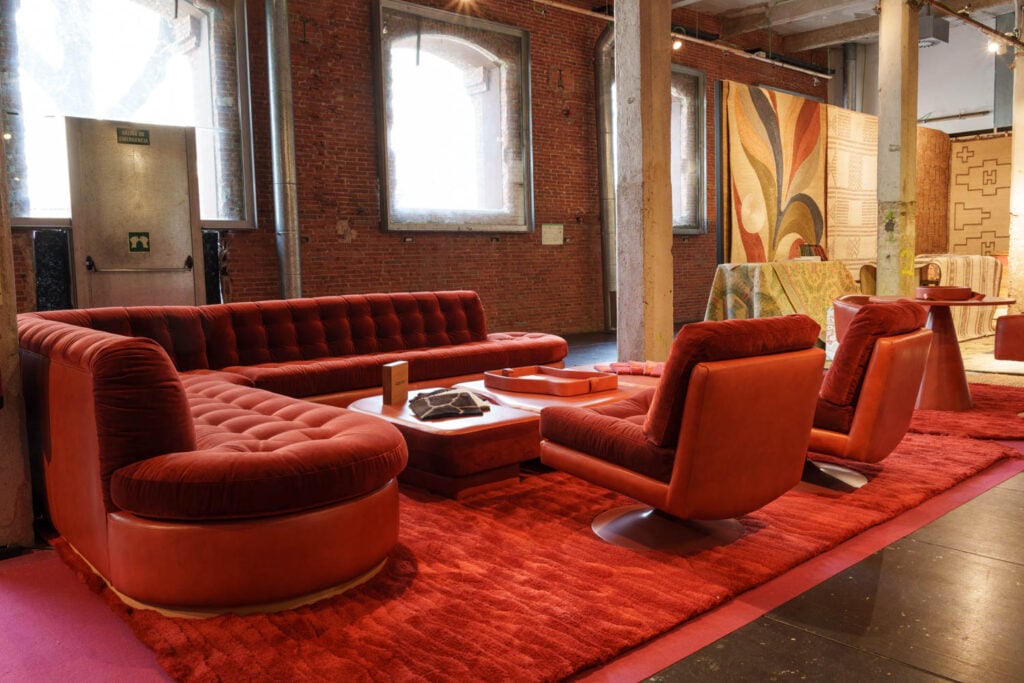 a red living room area with red sofas