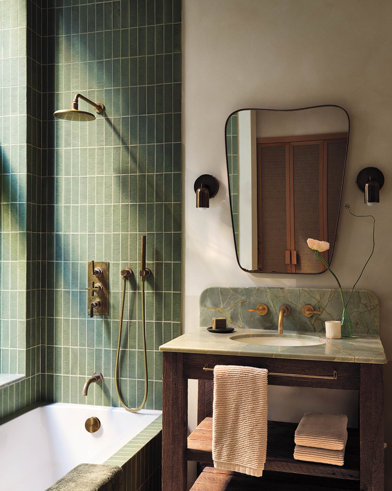 bathroom with green tile in shower