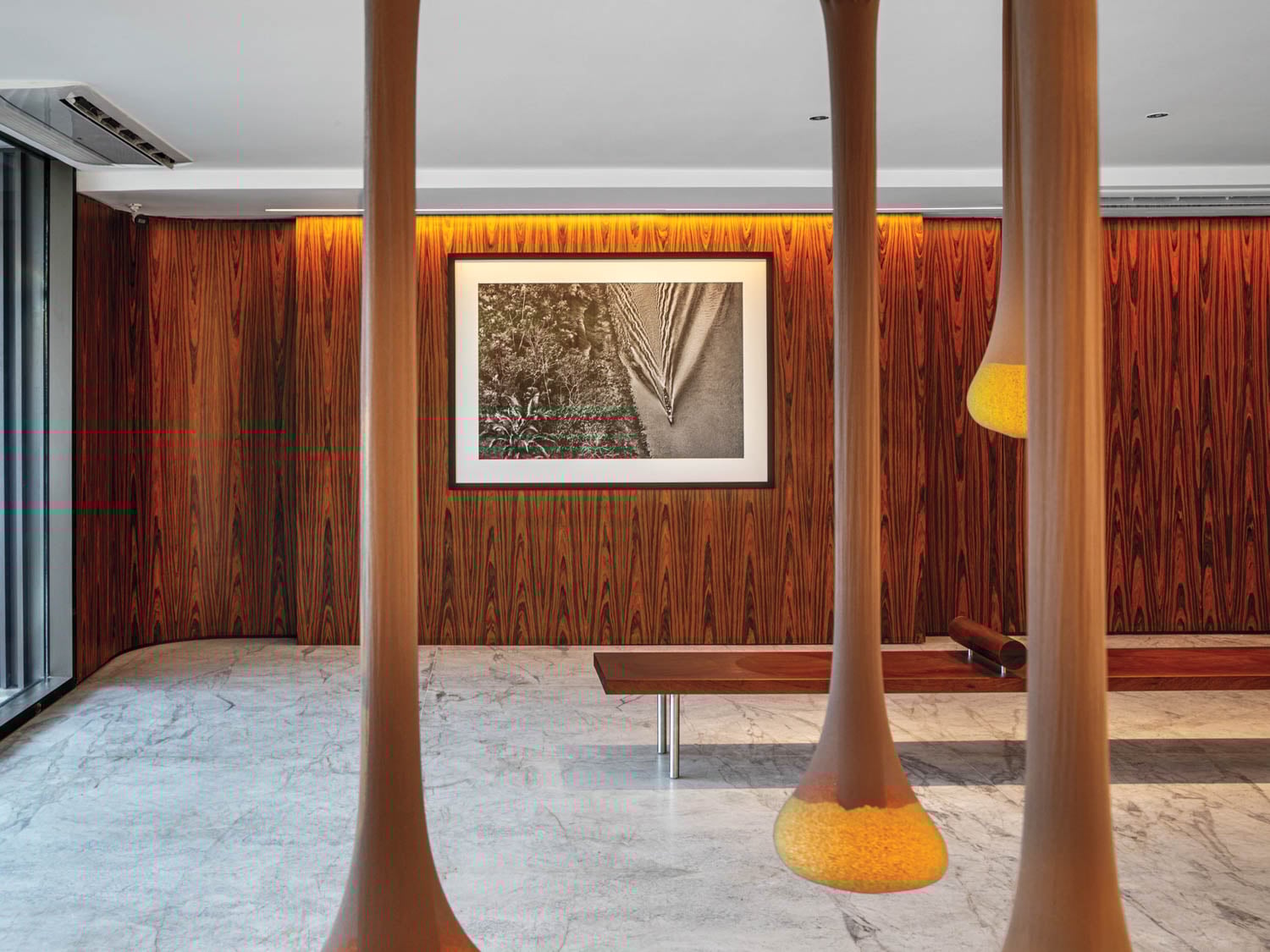 a room with wood columns and art