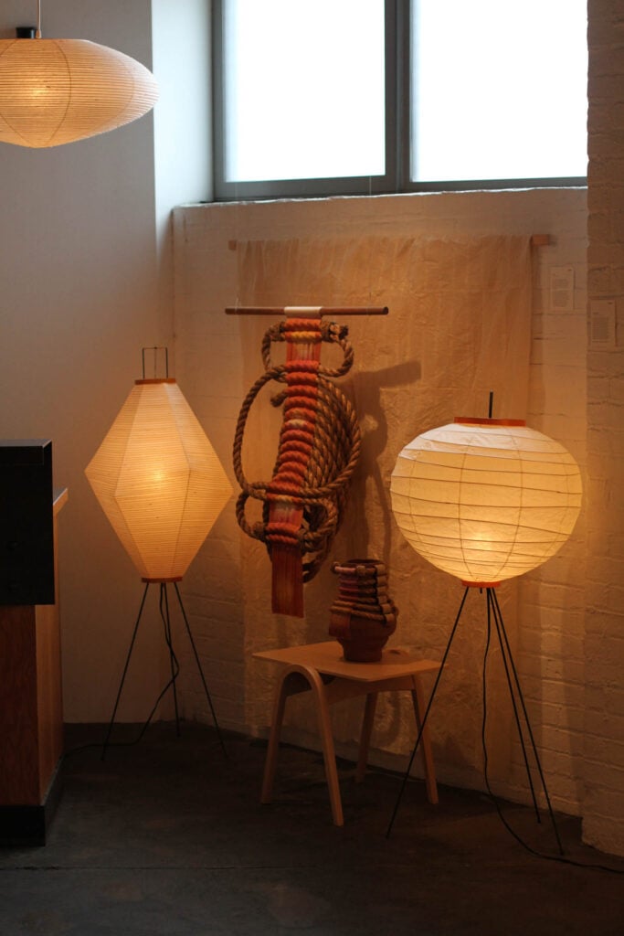 braided piece next to two lights