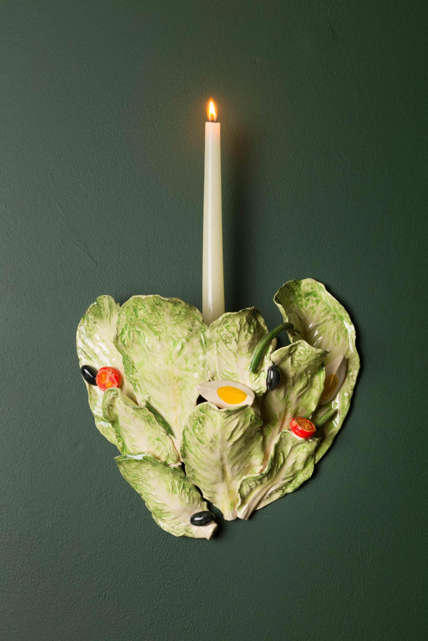 candle sticking out of cabbage