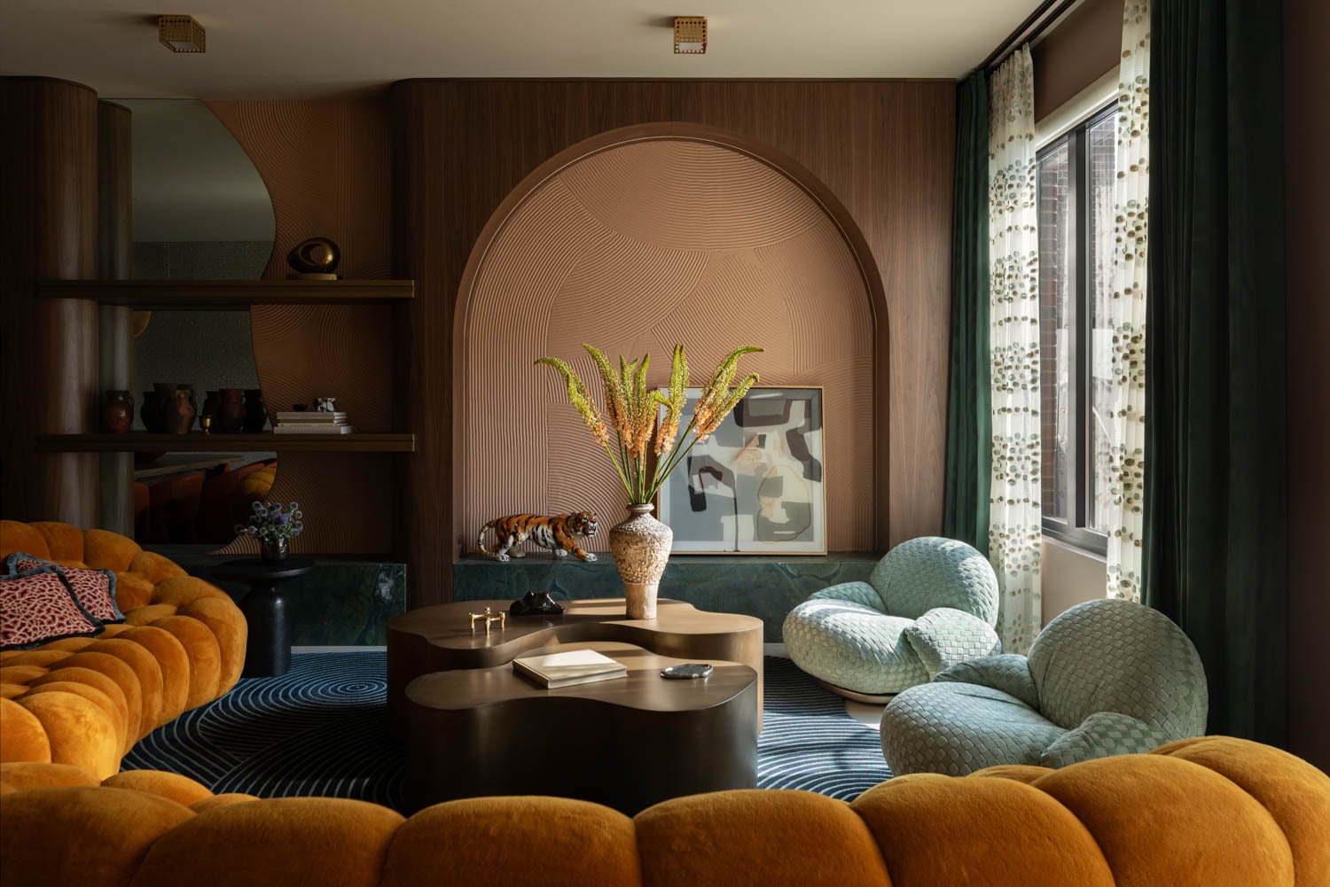 living room with yellow velvet couch and archway