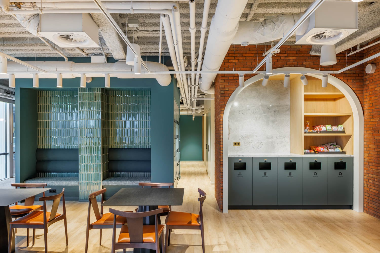 lounge area of an office with blue nook area and archways