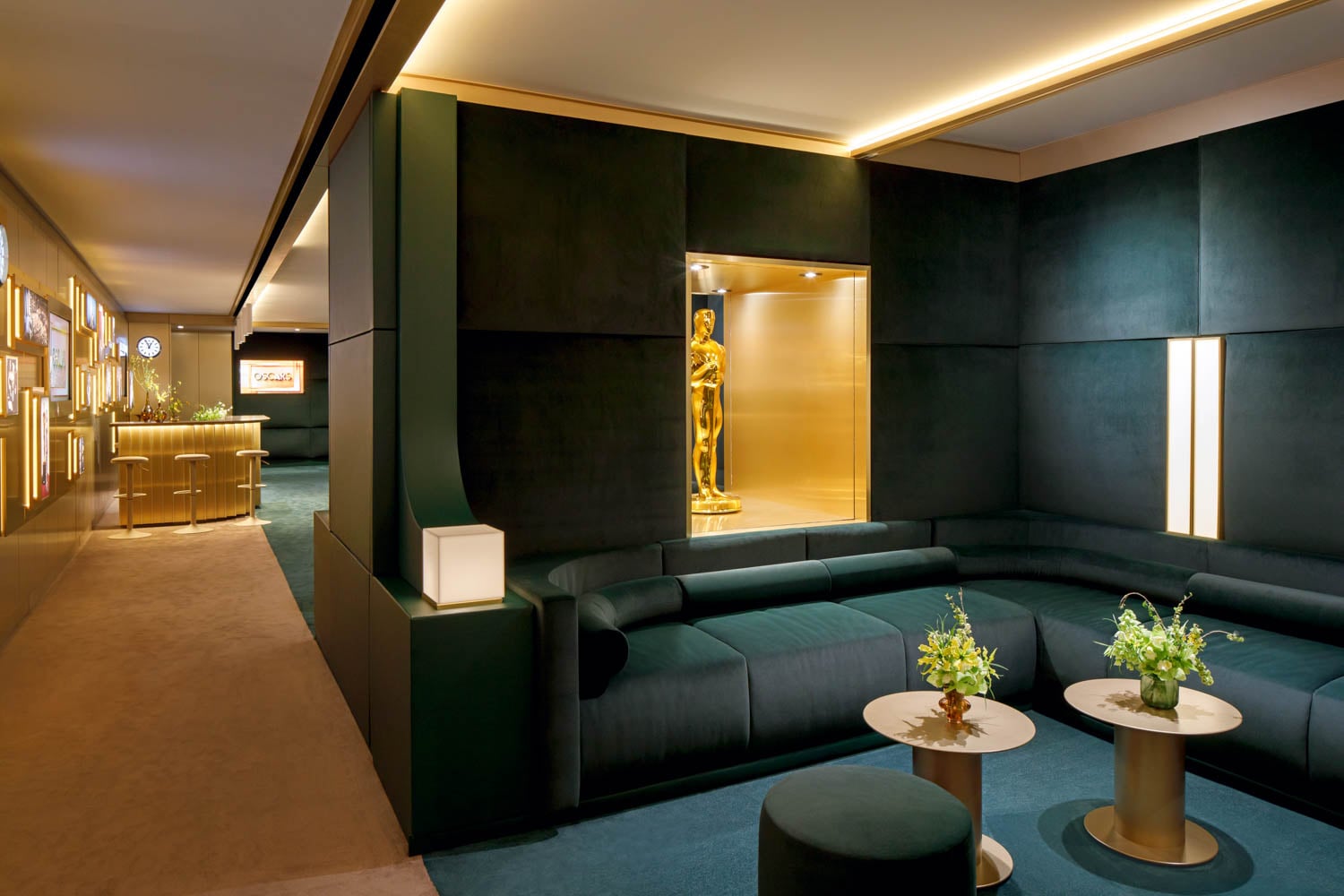 Luxurious lounge with dark green sectional sofas and golden lighting