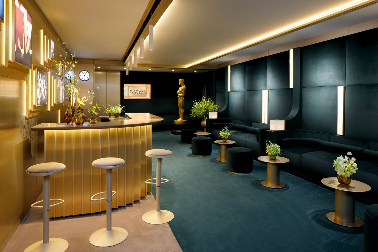 Luxurious lounge with a golden bar, modern stools, and a plush blue carpet.