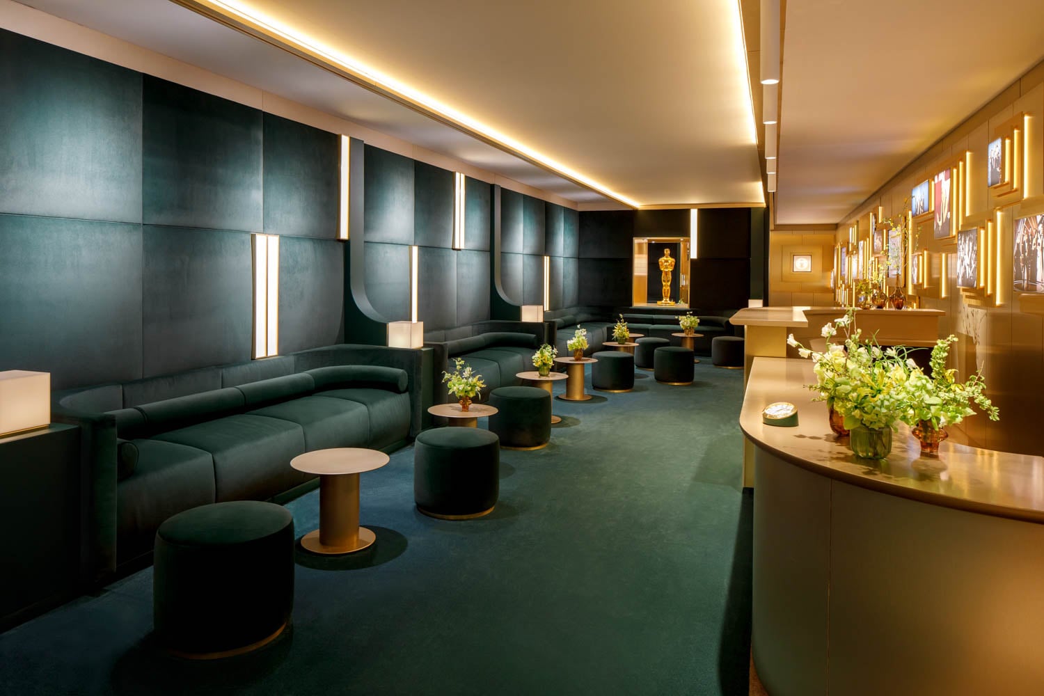 Luxurious lounge with teal velvet seating and circular tables topped with flower