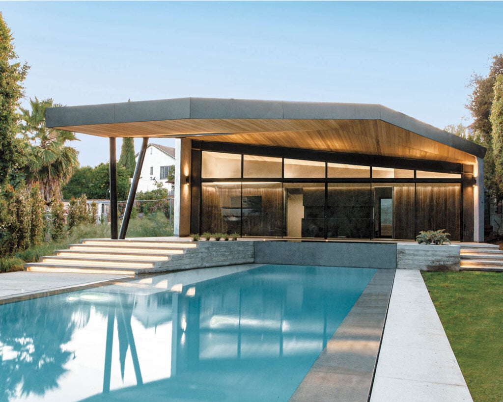 exterior facade of ADU with a pool and lawn