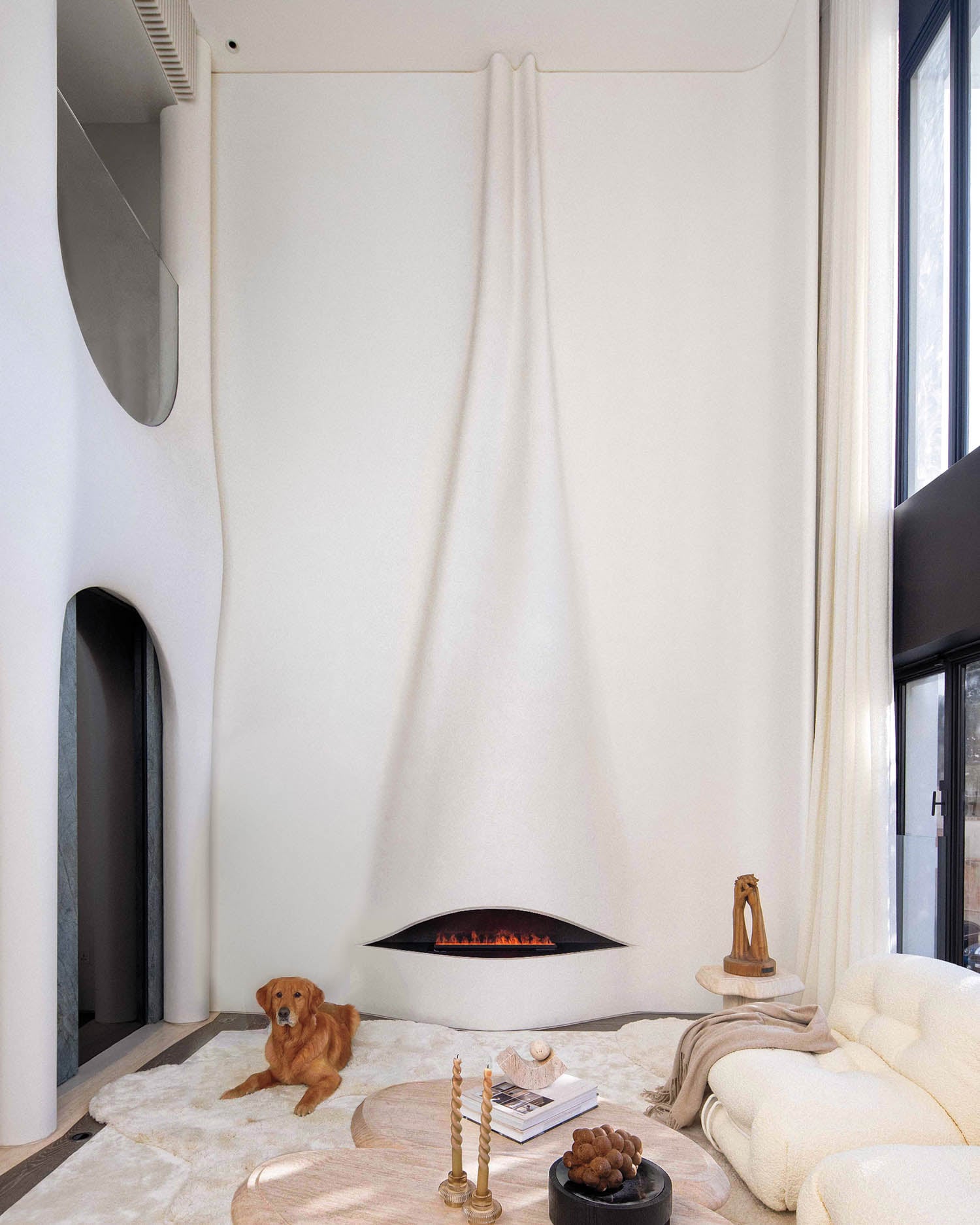 sitting area with couch, table and drapes