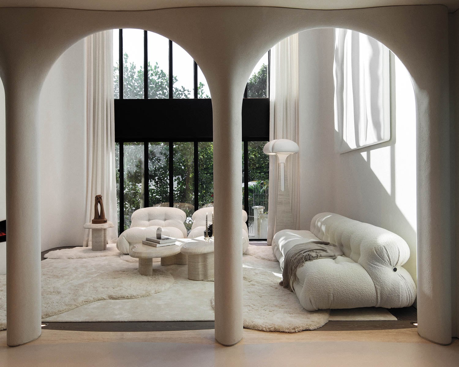 arched entryways into an all-white living room