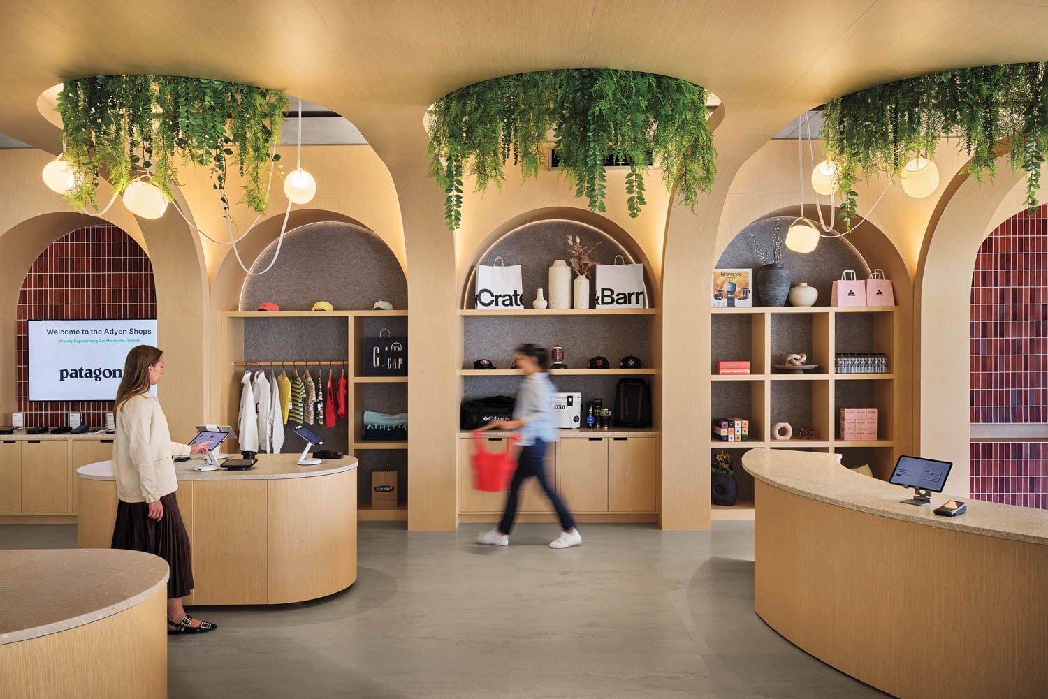 Modern store interior with curved wooden shelves, cascading greenery, and warm lighting