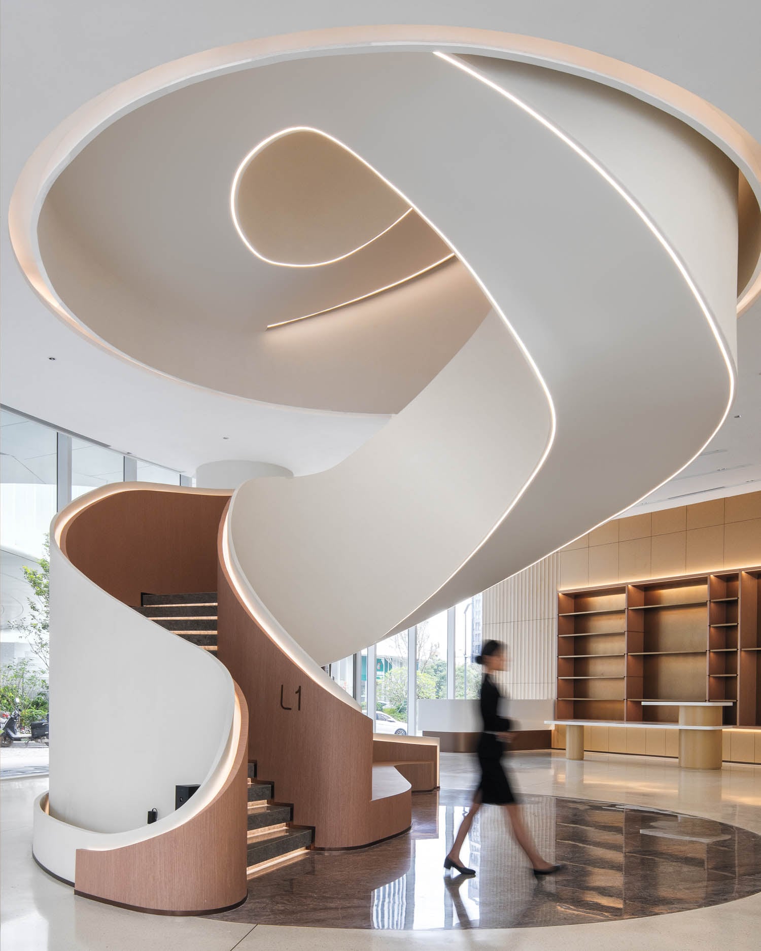 Modern interior with a spiral staircase featuring sleek curves and integrated lighting