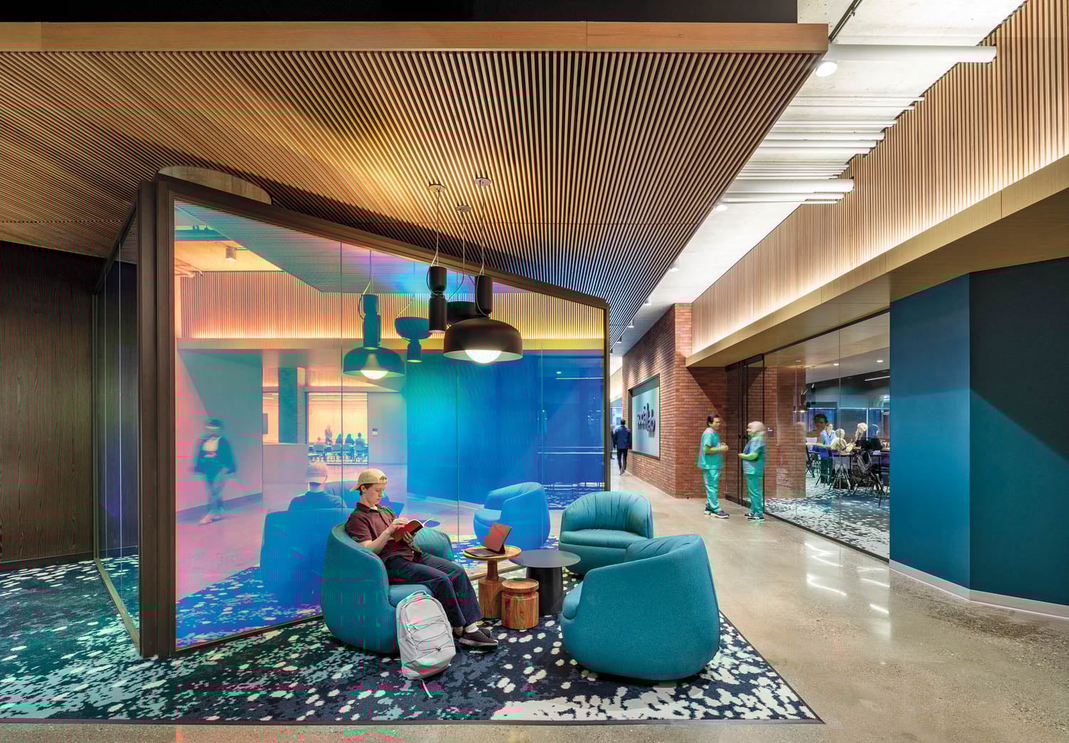 Modern lounge area with vibrant lighting and colorful glass walls