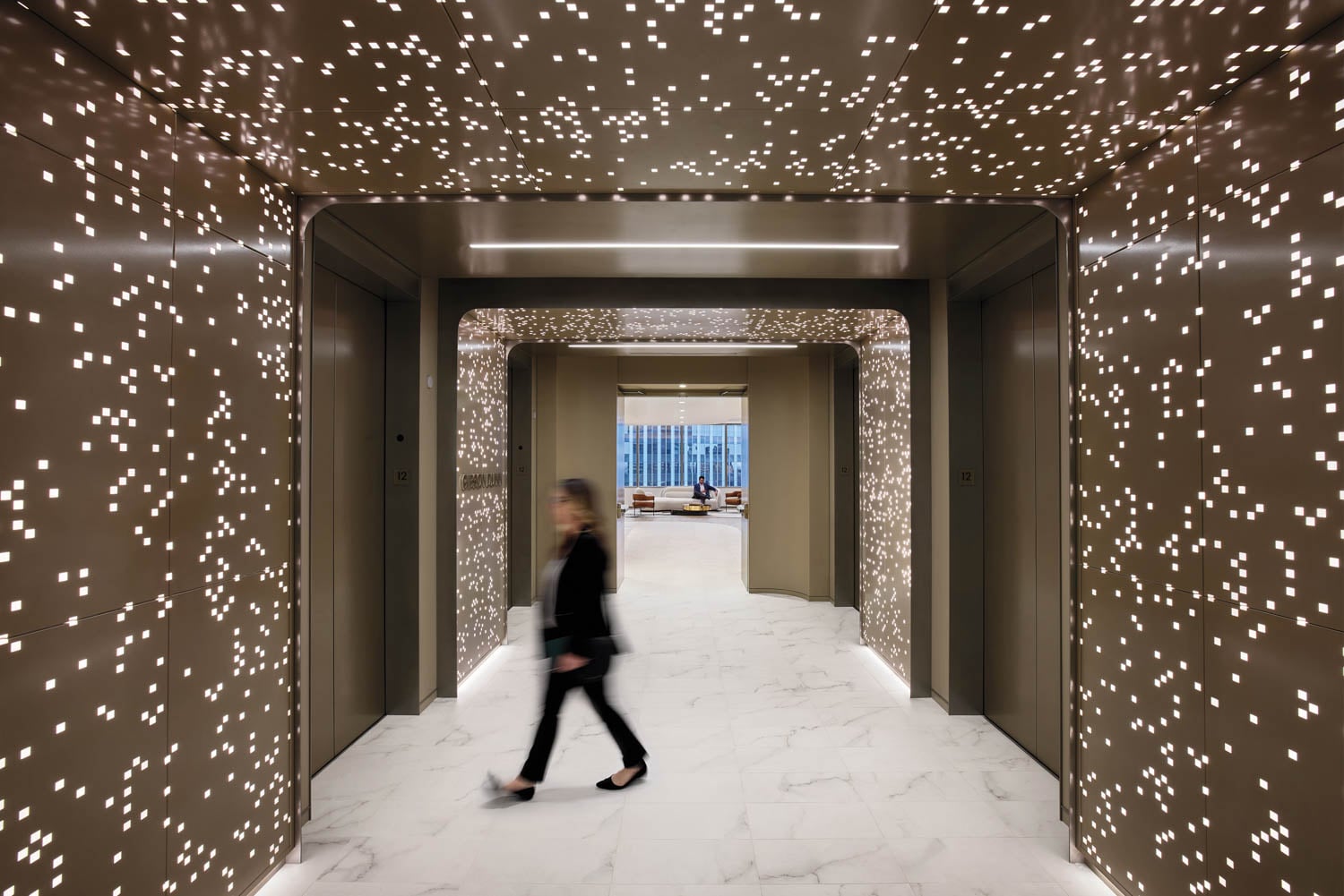 person walking through lit hallway