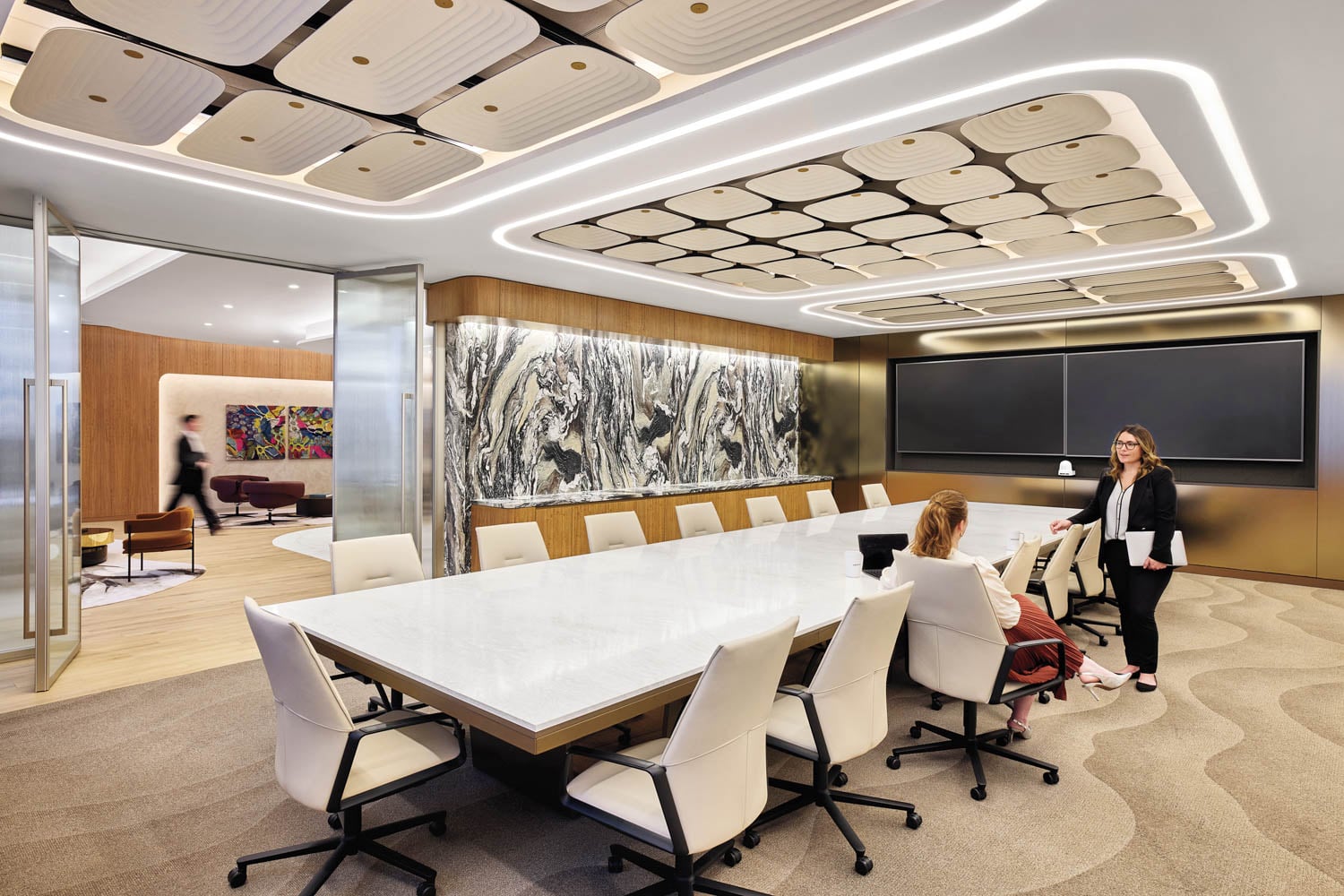 person standing at edge of conference table