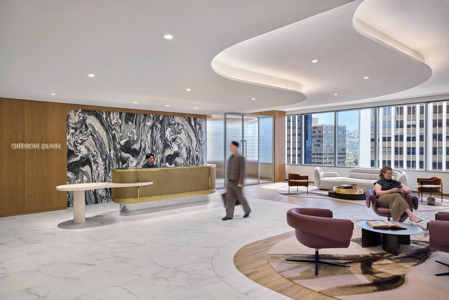 person walking through reception area with marble backdrop