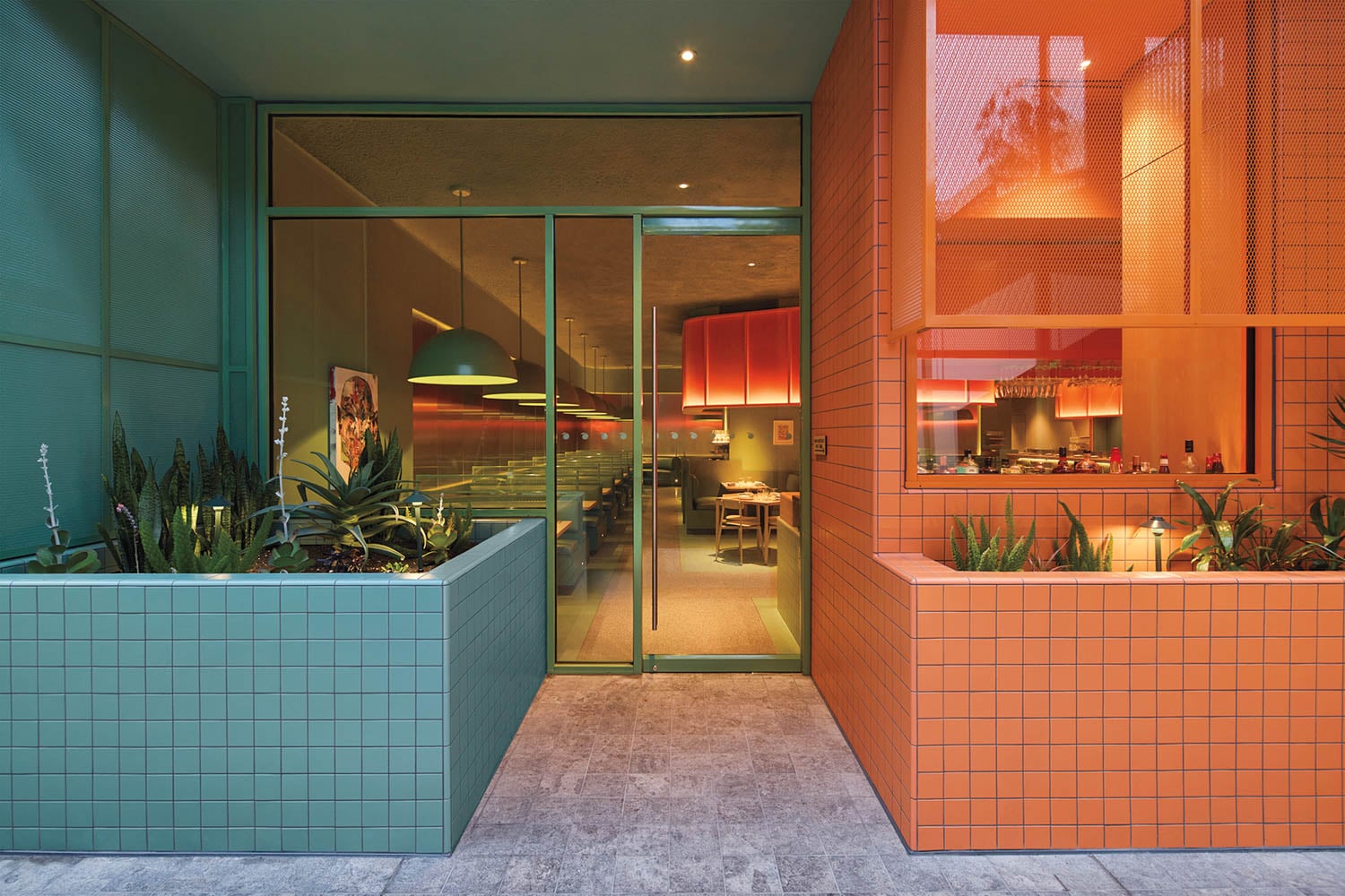 outside of restaurant with blue and coral pink planter boxes