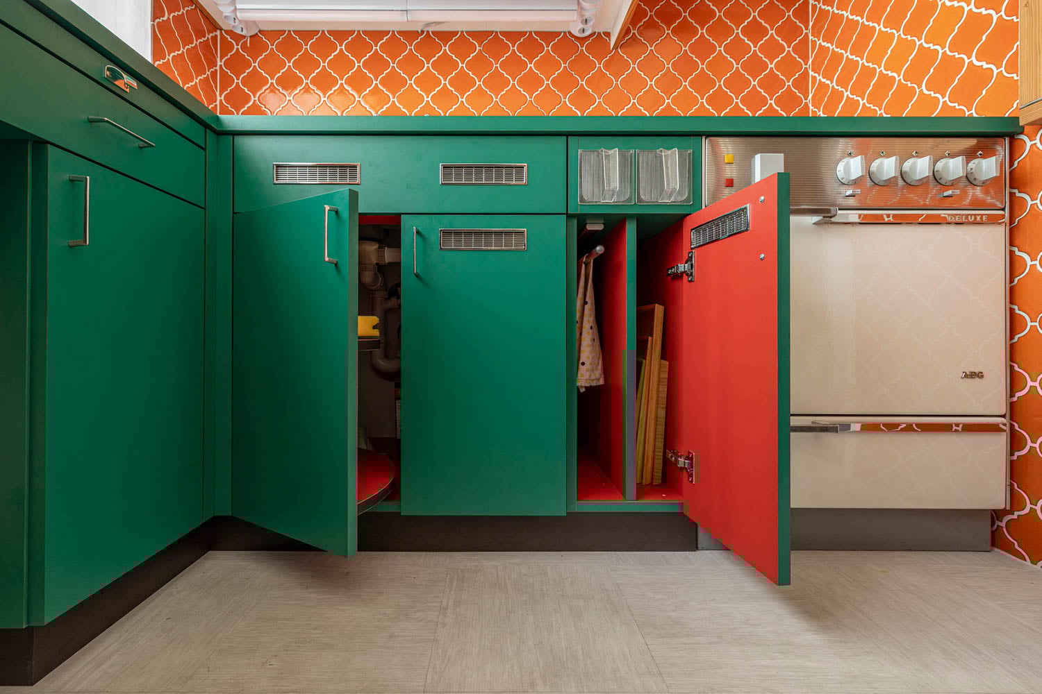 kitchen with green cabinets designed by Margarete Schütte-Lihotzky