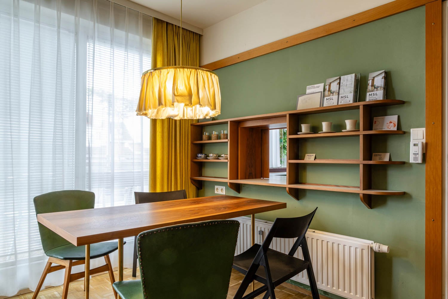 dining area with pale green walls and chairs