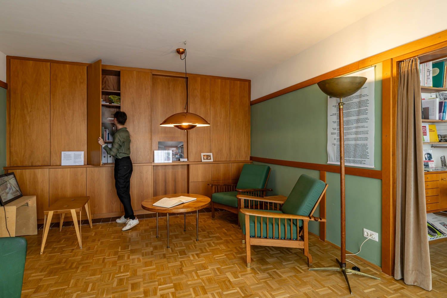 person opening up cabinets in room