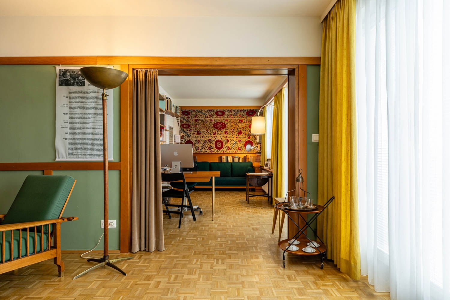 entryway to room with green chair and light designed by Margarete Schütte-Lihotzky