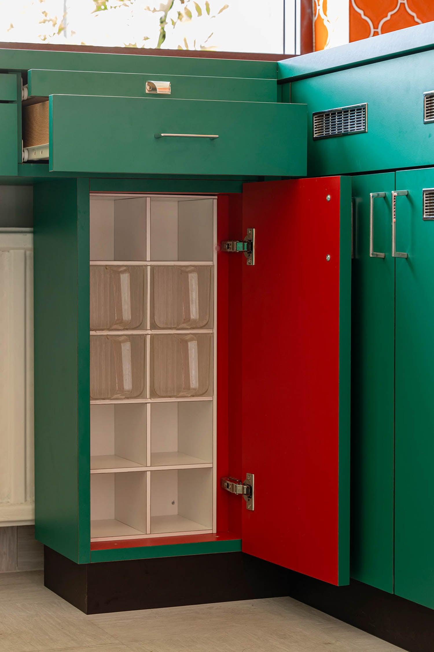closeup of green cabinet with glasses designed by Margarete Schütte-Lihotzky