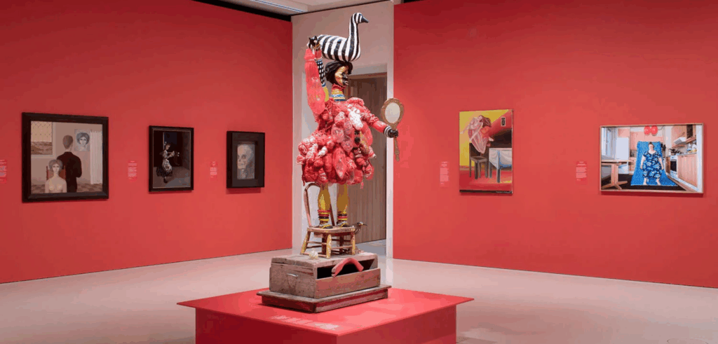 woman in middle of red room with striped bird