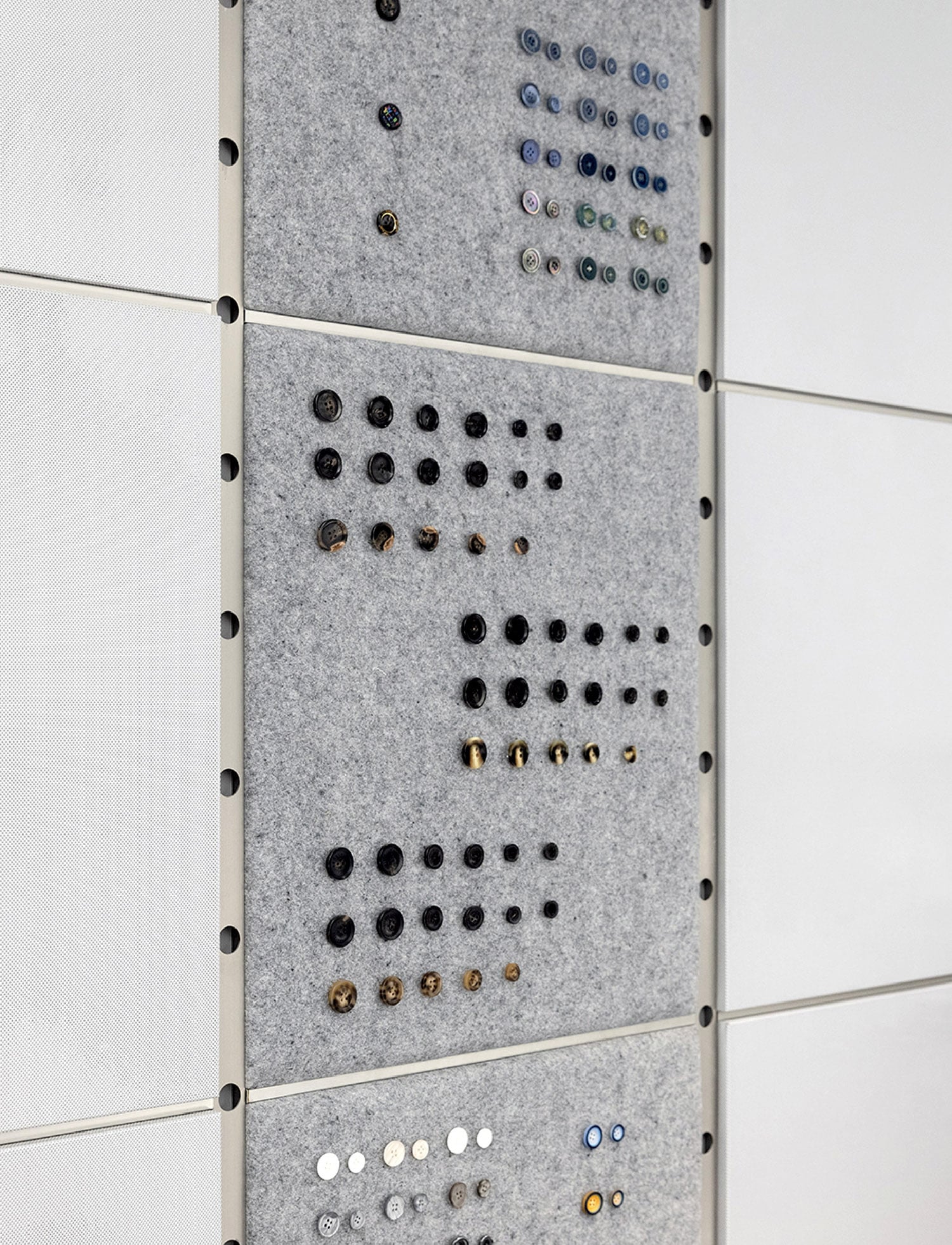 A wall with a bunch of buttons on it.