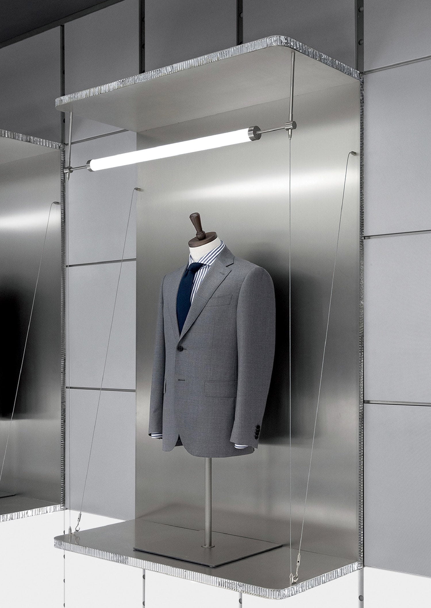 A suit and tie hanging on a wall.