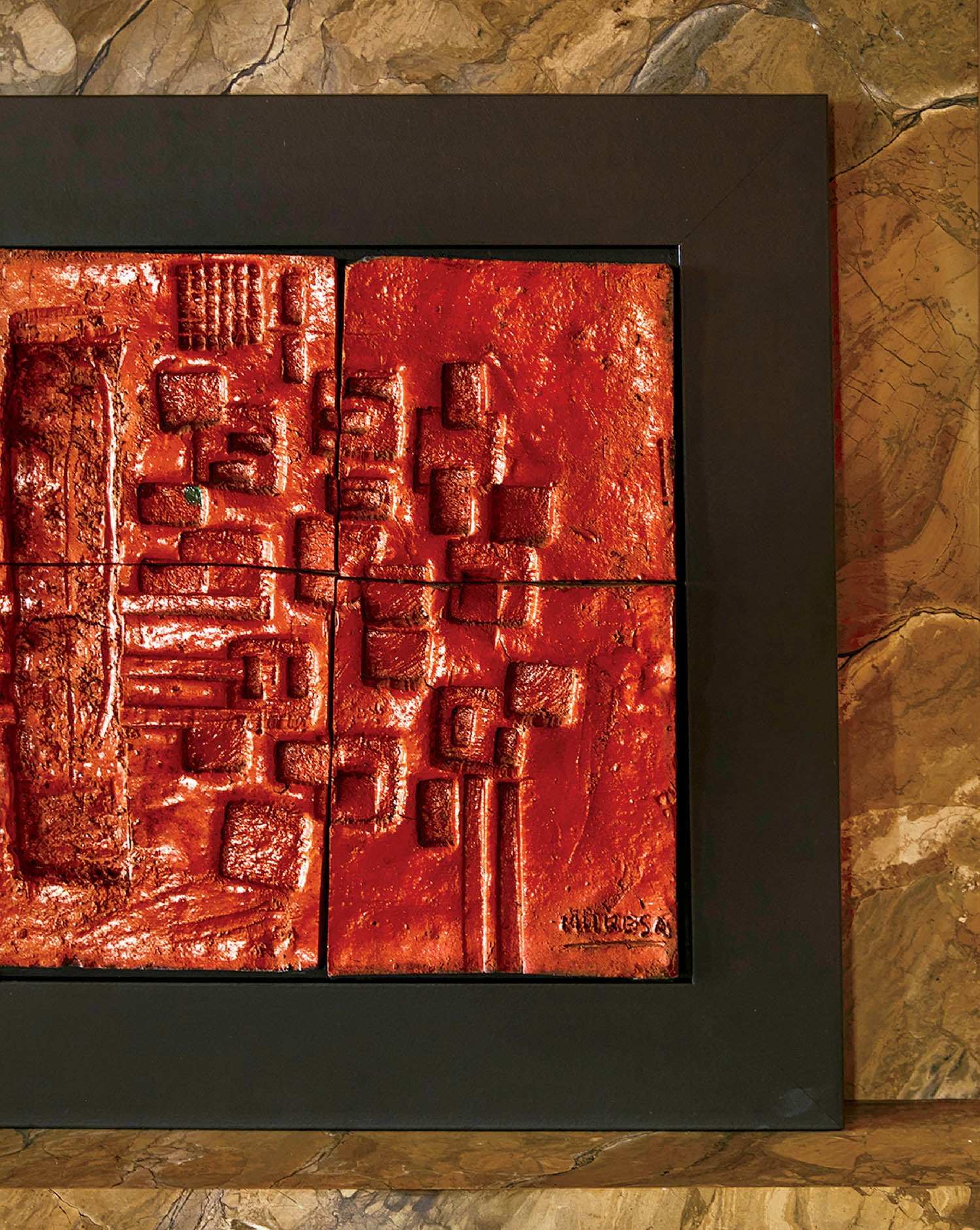 A picture of a red painting on a wall.