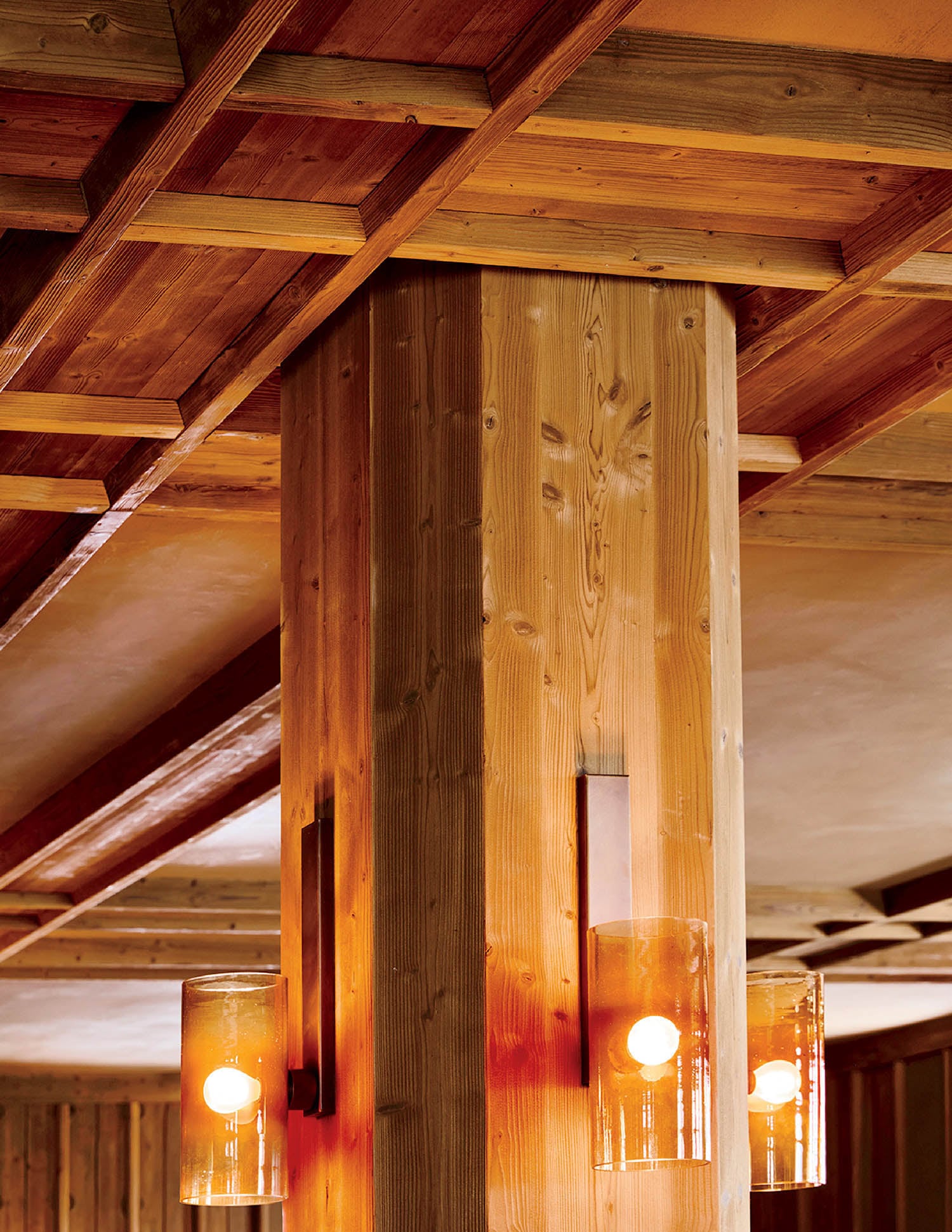 A wooden ceiling with three lights hanging from it.