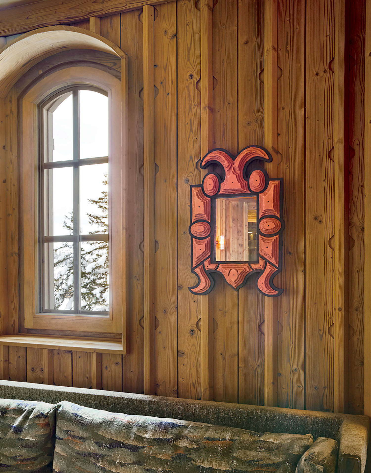 A living room with a couch and a window.