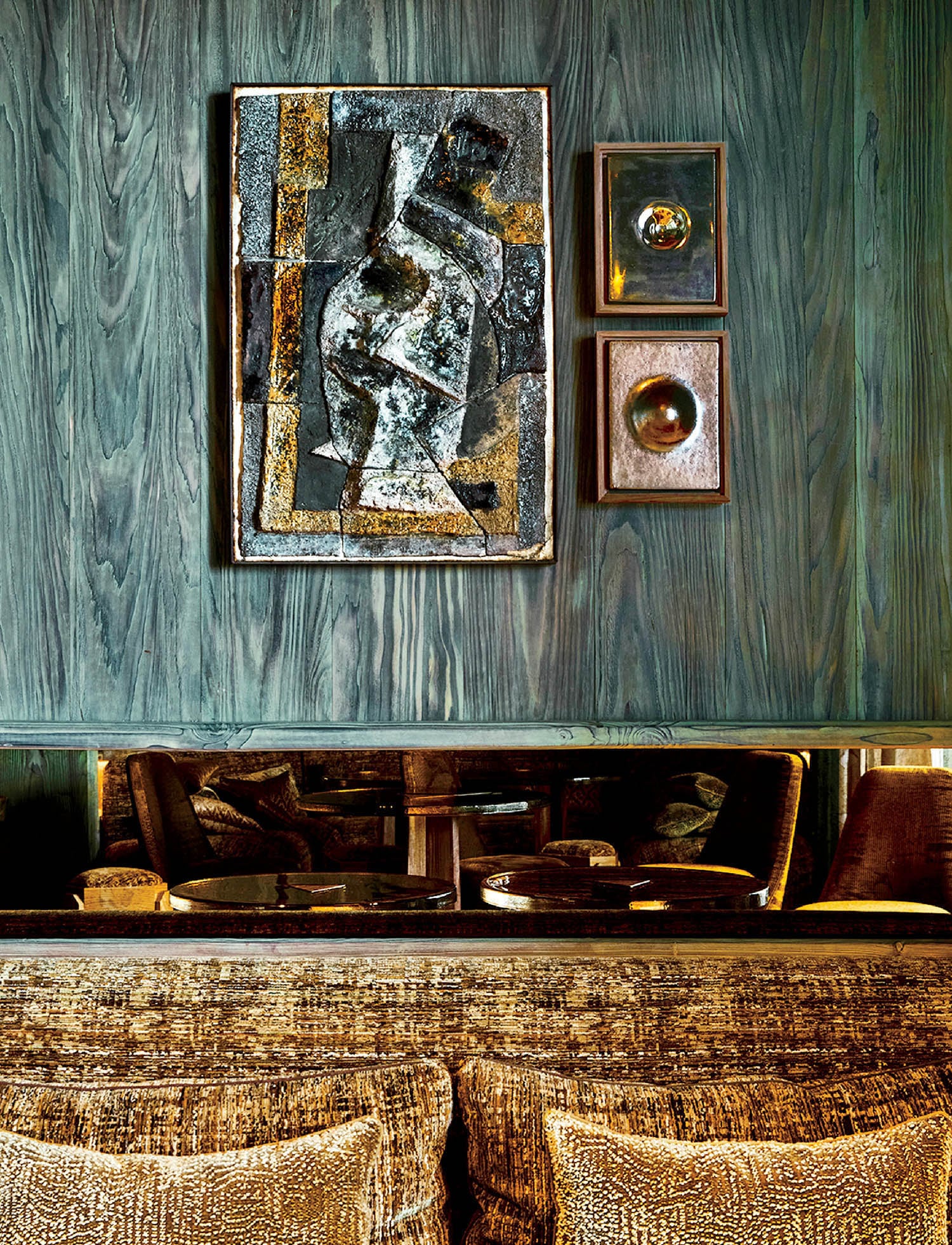 A bed with a painting on the wall.