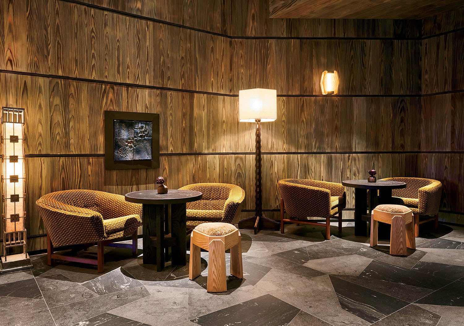 A room with a table and chairs and a painting.