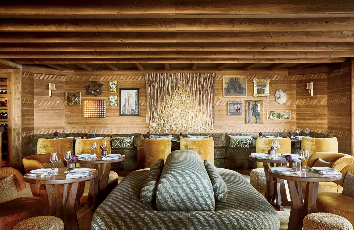 A restaurant with a large couch and a table.