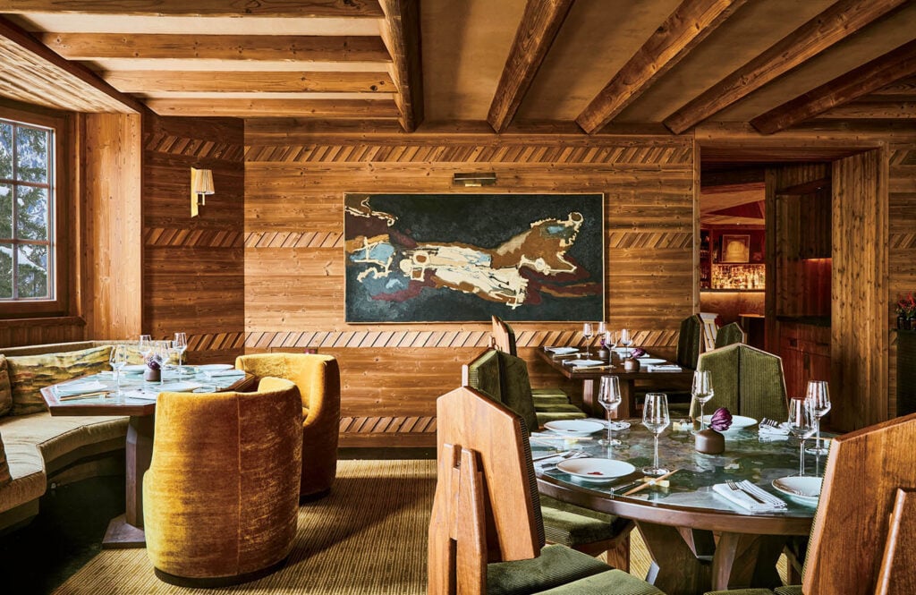 A restaurant with a large painting of a cowboy on the wall.