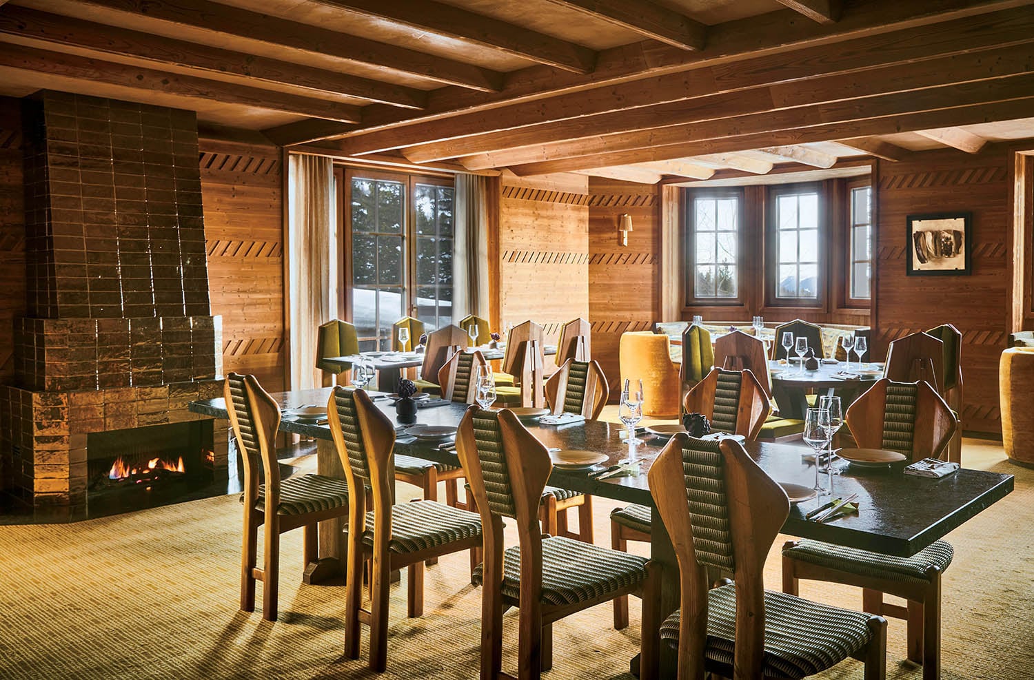 A dining room with a fireplace and a table.