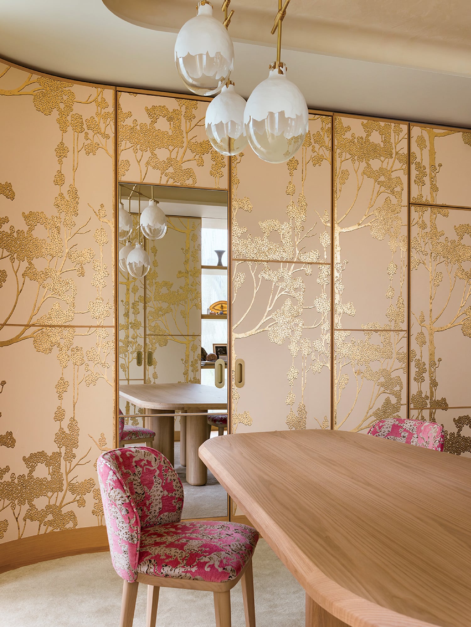 A dining room with a table and chairs