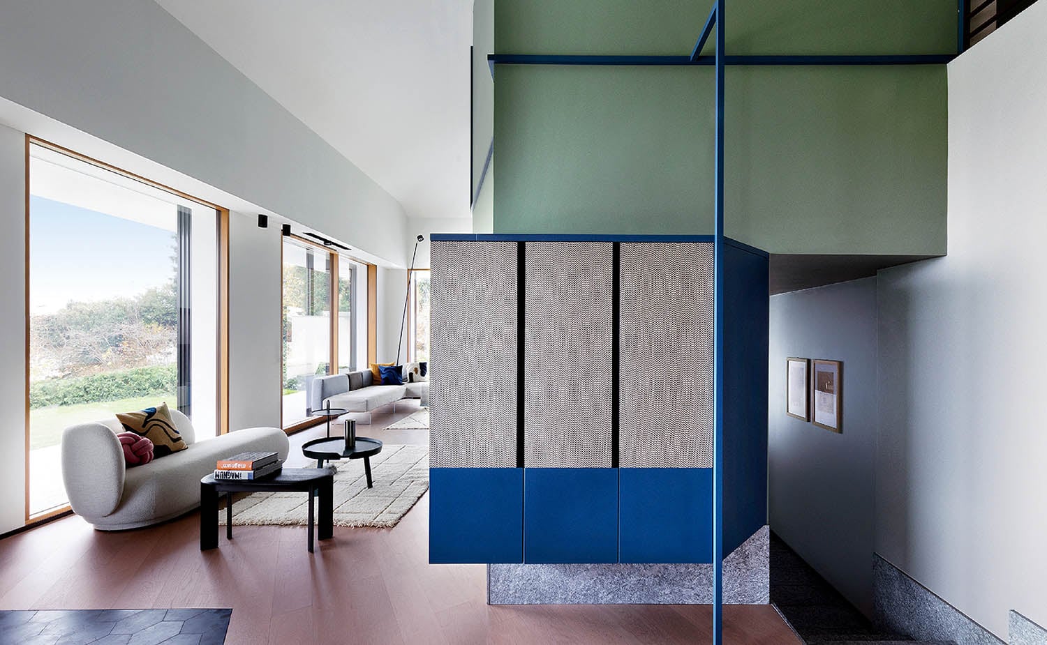 A living room with a blue door and a white couch.