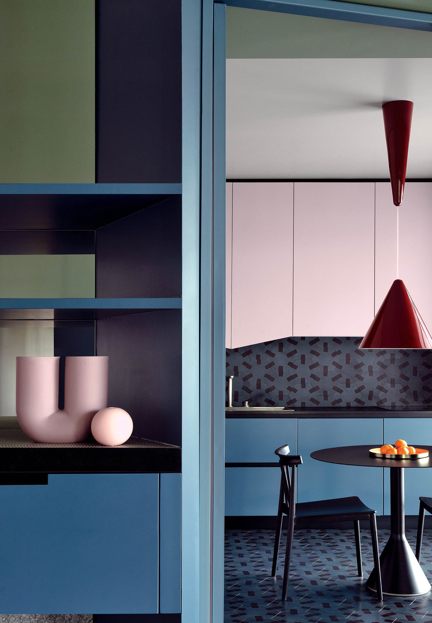 A kitchen with a table and a chair.