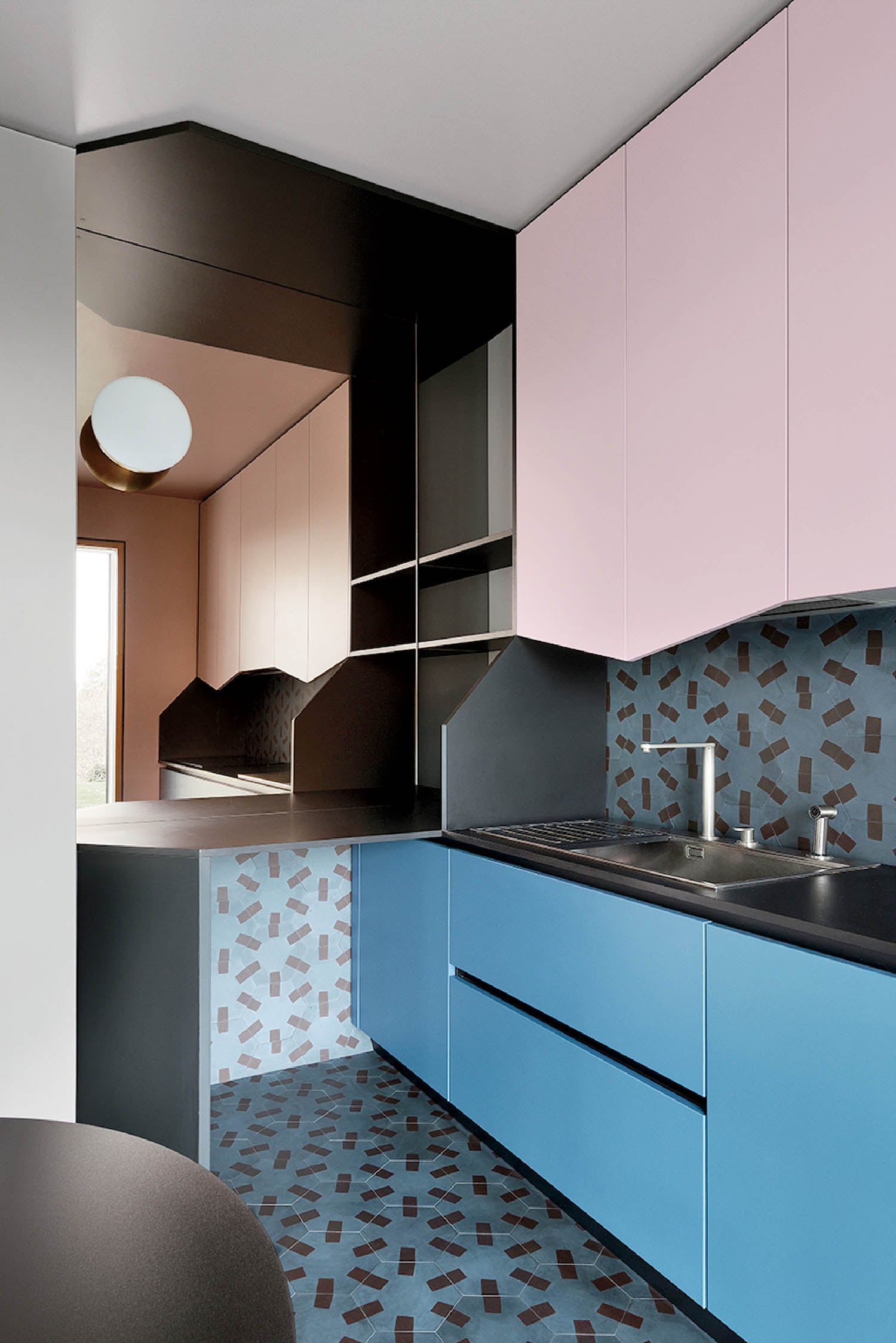 A kitchen with a blue and pink color scheme.