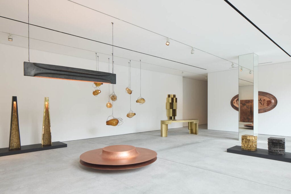 copper basin with hanging art above