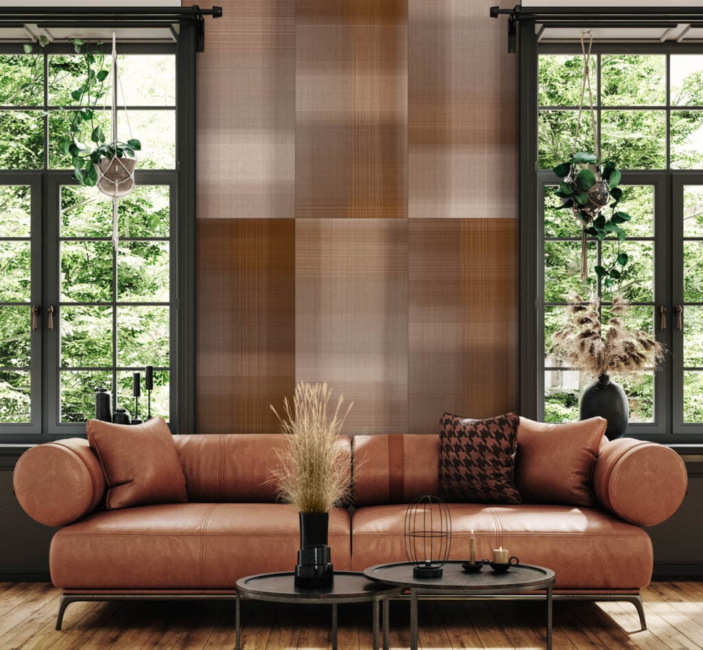 sofa kulit dekat dinding ubin berwarna coklat