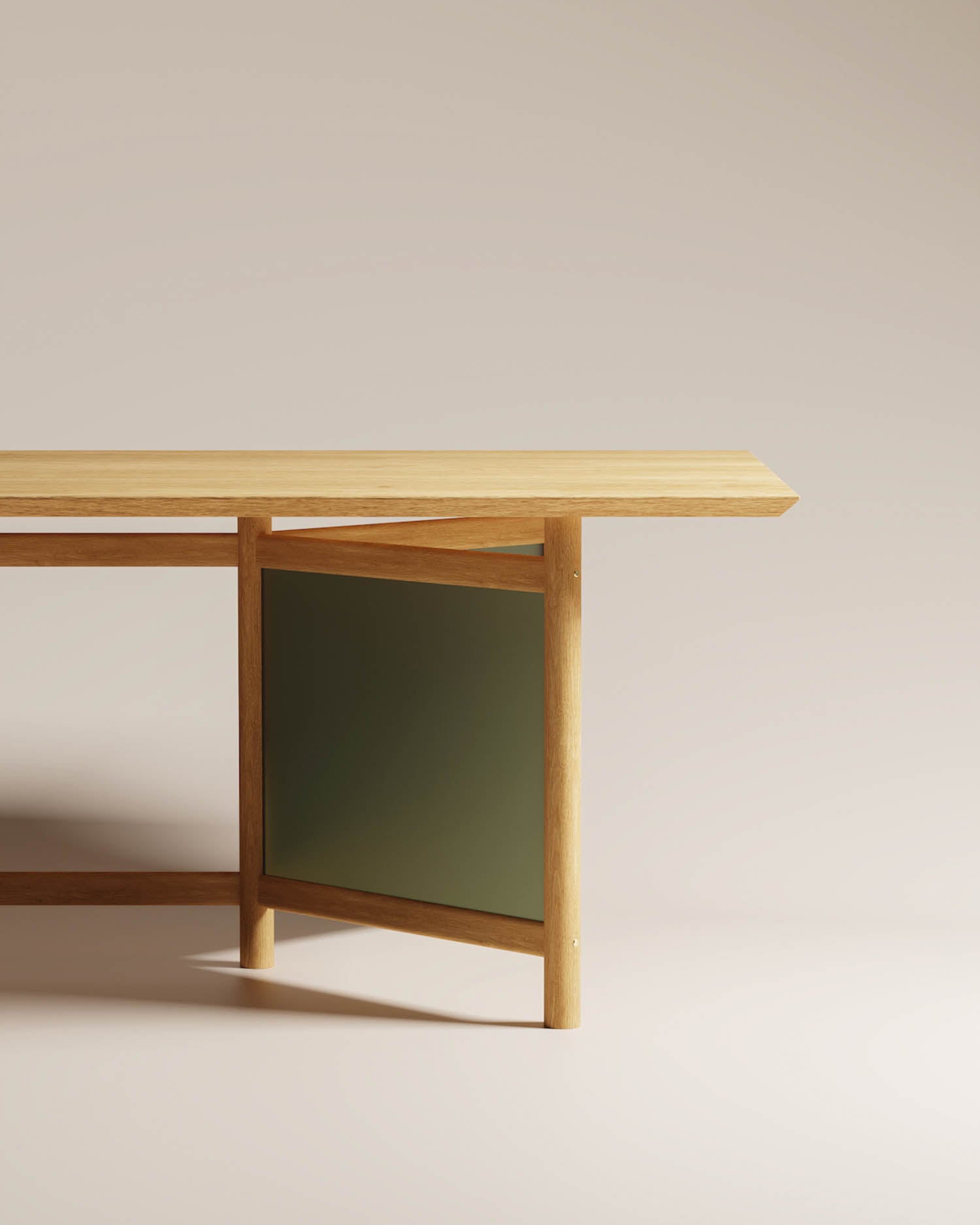 A wooden table with an angled top and a green panel between two legs, set against a plain beige background.