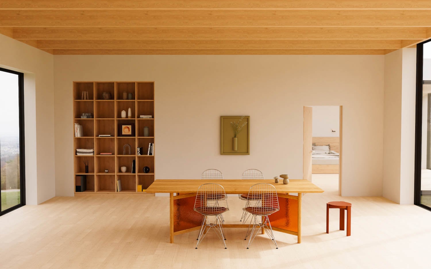 Minimalist dining area with a wooden table, three wire chairs, a red stool, built-in shelves, and a doorway leading to a bedroom. Large windows bring in natural light.