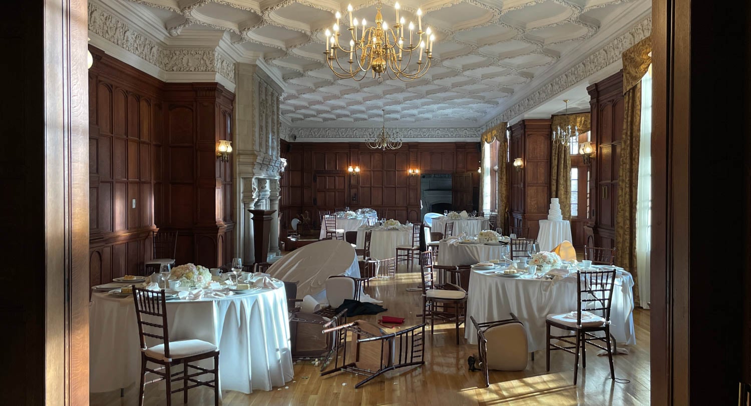 venue with white tablecloths and chandelier