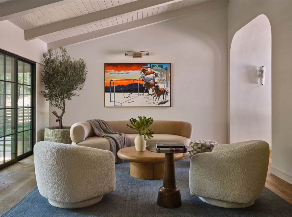 living room with cream chairs and sofa