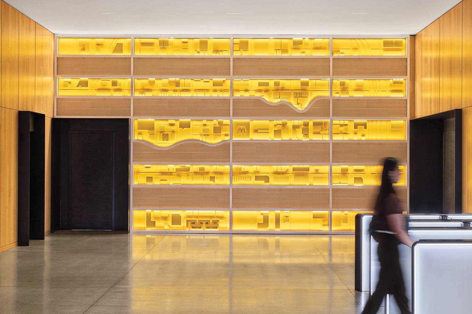 a backlit installation dubbed the “cheese wall” adjoins the elevator lobby