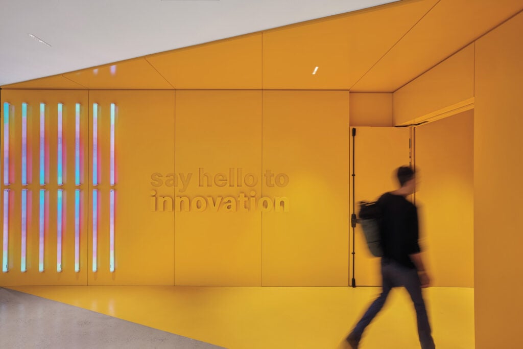 a person walking through a yellow hall