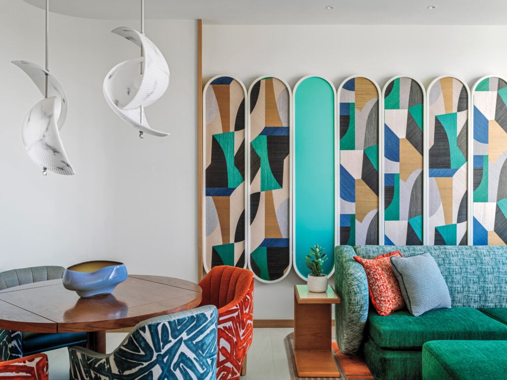 hotel room with green couch and table with red chair
